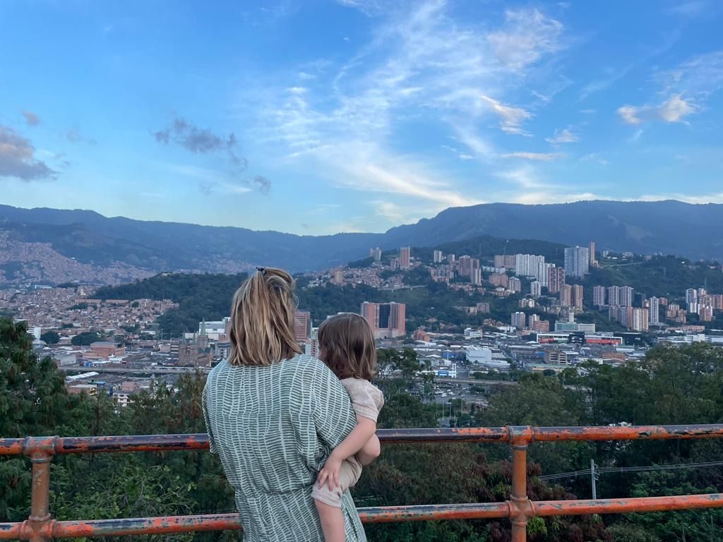 Une maman et son bébé face à la vue sur Medellín et ses montagnes