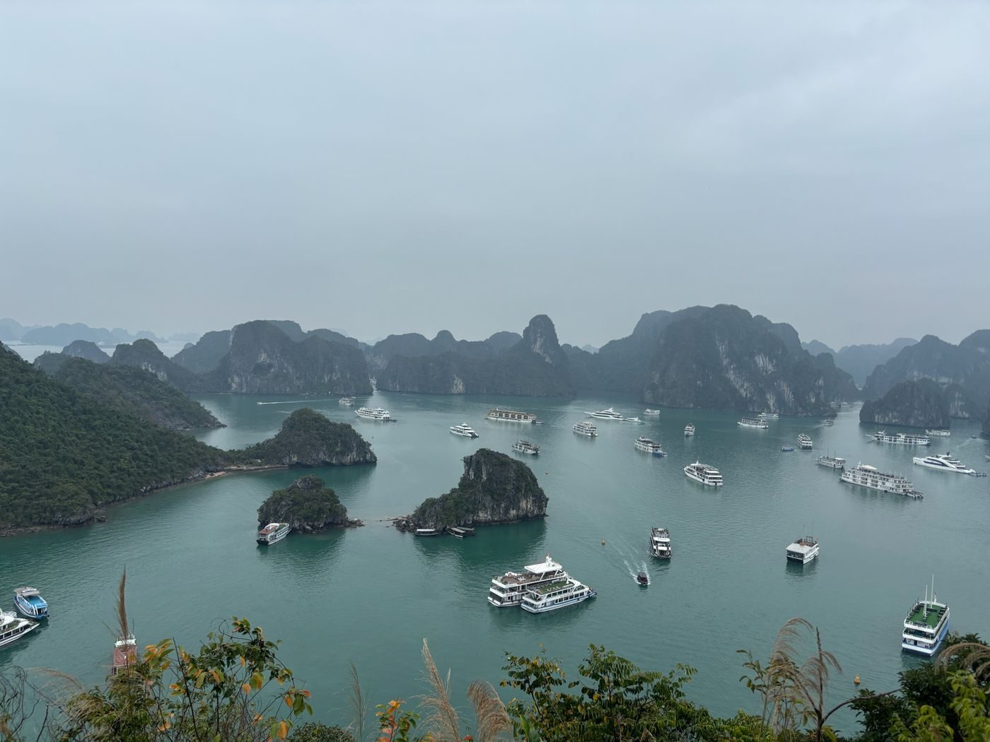 Vue panoramique sur les pitons calcaires et les bateaux de la baie d'Halong